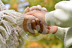 Elderly couple holding hands