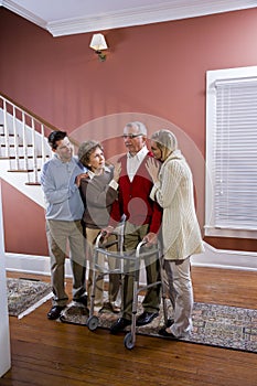 Elderly couple at home with adult children