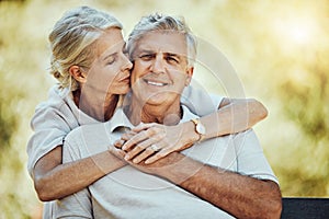 Elderly, couple with hug in park and retirement with marriage, love and partnership, outdoor in nature. Portrait, kiss