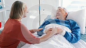 Elderly couple, husband and talking in hospital bed or happy connection for good news, checkup or visit. Wife, man and
