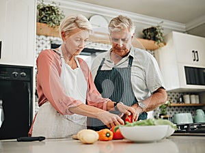 Elderly, couple and kitchen for cooking with vegetables for dinner with nutrition food. Man, woman and in retirement