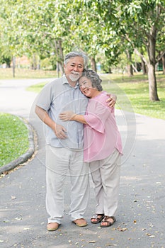 Elderly couple with lifestyle after retiree concept. Lovely asian seniors couple embracing together in the park in the