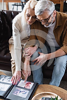 Elderly couple looking at photos in
