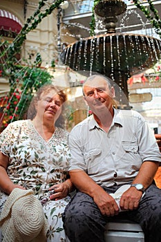 Elderly couple with lovely smiles sitting in front photo