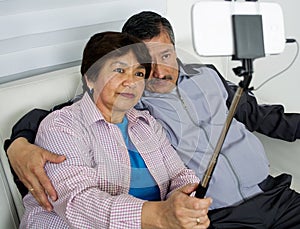 Elderly Couple Making Selfie On Phone At Home