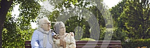 An elderly couple man and women of Asian incursion, happily spend time in a city park
