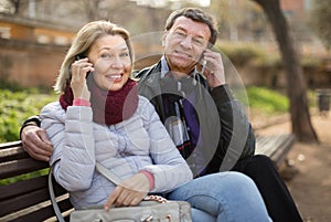 Elderly couple with mobile phones