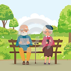 Elderly couple in the park with gadgets