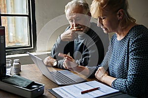 Elderly couple planning on life insurance plan photo