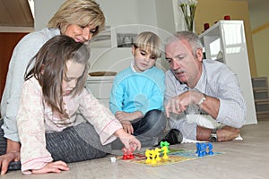 Elderly couple playing with grandchildren