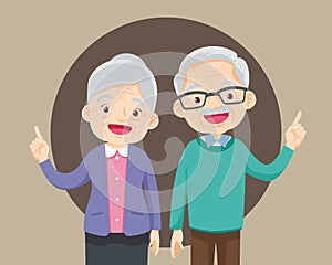 Elderly couple pointing finger up