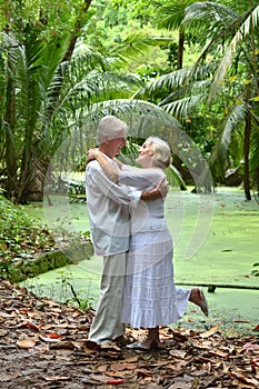 Elderly couple rest at tropical beach