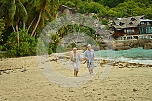 Elderly couple running on beach