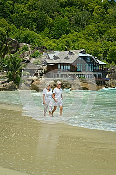 Elderly couple running on beach