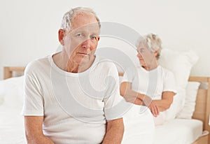 Elderly, couple and sad in bedroom with conflict, ignore and crisis in marriage for mental health or retirement. Senior