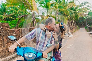 Elderly couple on scooter traveling summertime dating relationship concept