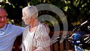 Elderly couple sitting on a bench park