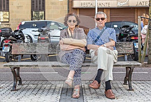 Elderly couple sitting on a bench in Spain