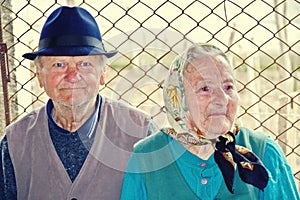 Elderly couple sitting together on a country road