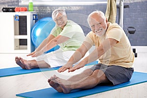 Elderly couple stretching photo