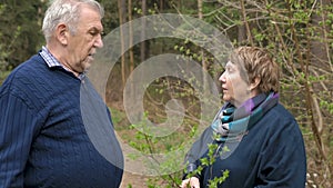 An elderly couple is talking on a walk in the park. Swear, find out the relationship.