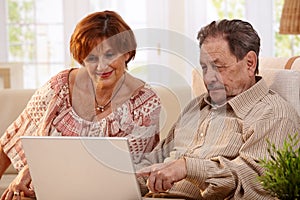 Elderly couple using computer computer