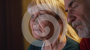 Elderly couple watching sad film together