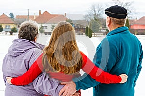 Elderly couple and young caregiver