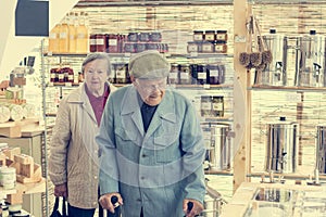 Elderly couple in a zero waste store bulk shopping.