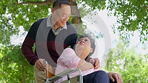 Elderly couples or caregivers take care of the patient in a wheelchair. Concept of a happy retirement with care from a caregiver