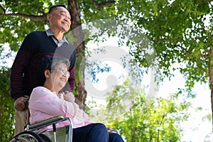 Elderly couples or caregivers take care of the patient in a wheelchair. Concept of a happy retirement with care from a caregiver