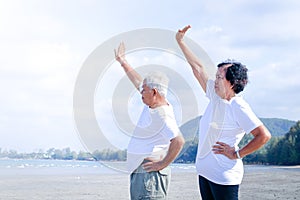 Elderly couples exercise in the morning on the beach by the sea