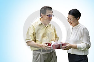 Elderly couples give gifts to each other,isolated on blue background with clipping path