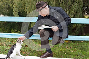 Elderly disabled man stroking a cat