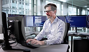 Elderly Engineer Developing Cyber Security Program