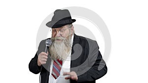 Elderly entertainer talking into microphone.