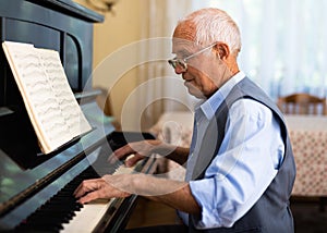 Compositor creating new music with piano at home photo