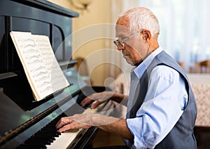 Compositor creating new music with piano at home photo