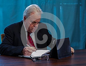 Elderly executive at boardroom table