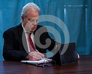 Elderly executive at boardroom table