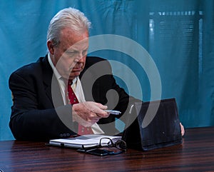 Elderly executive at boardroom table