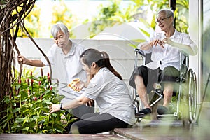 Elderly family doing leisure activities,planting trees during stay home,spending time together,asian woman help and take care her