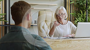 Elderly female boss communicate with subordinate. Recruiting new candidate at job interview