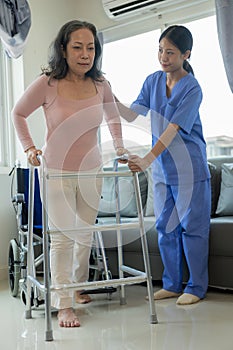 Elderly female patient with Asian female physical therapist holding her arm for physical therapy Rehabilitate weak muscles.