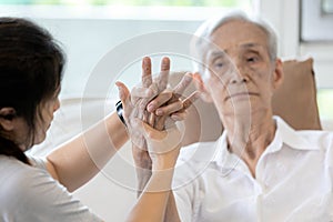 Elderly female patient suffer from numbing pain in hand,arthritis,tendon inflammation,stiffness of the joints,asian senior woman photo