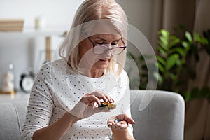 Elderly female pensioner having daily medicines at home