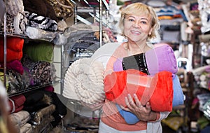 elderly female purchaser holding soft plaids
