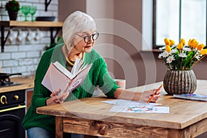 Elderly female trying to understand vedic charts using book