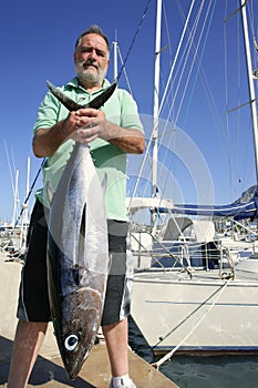 Elderly fisherman with Albacore tuna catch