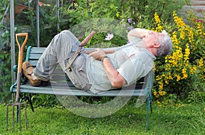 Elderly gardener sleeping on the job.